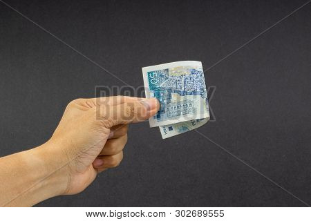 Hand Holding Fifty Croatian Kuna Or Sto Kuna Bank Notes On Black Background. Financial Concept And S