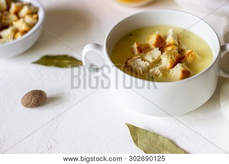 Cheese Cream Soup On A White Background. White Bread Croutons. Ingredients.