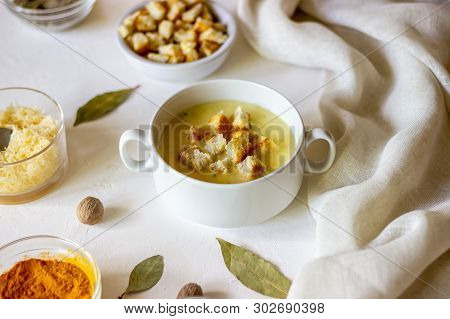 Cheese Cream Soup On A White Background. White Bread Croutons. Ingredients.