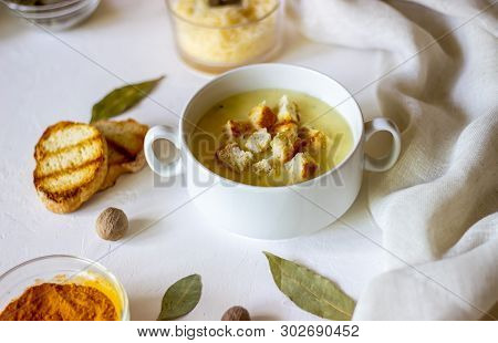 Cheese Cream Soup On A White Background. White Bread Croutons. Ingredients.