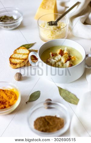 Cheese Cream Soup On A White Background. White Bread Croutons. Ingredients.