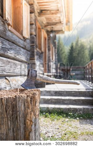 Getting Wood For Fire: Axe Attached To A Tree Trunk