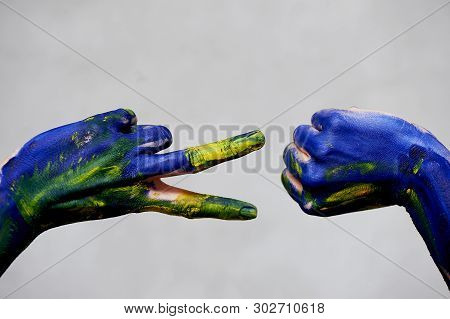 Graceful Hands Of The Artist . Hands In Blue And Yellow Paint. Creator, Creativity.yoga For Hands.a 