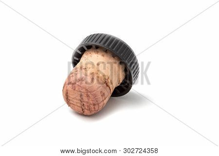 Cork For Wine With A Black Plastic Hat. Isolated On White Background.