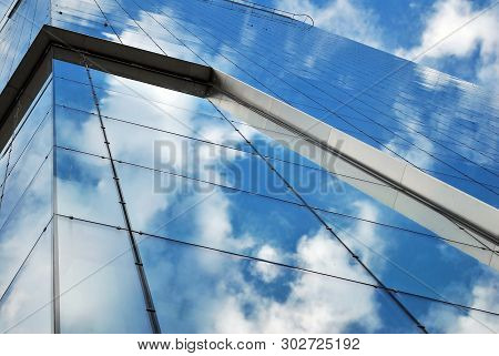 Surface Of Glass Building With The Reflection Of Clouds