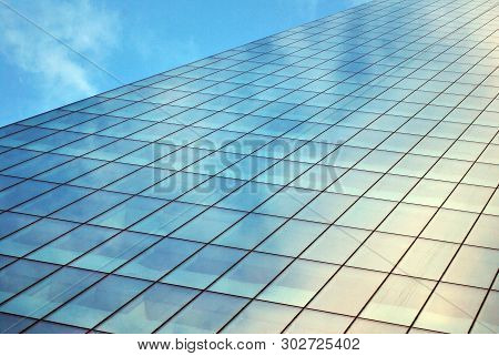 Surface Of Glass Building With The Reflection Of Clouds