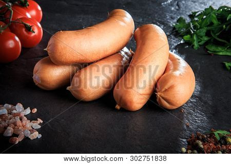 Macro Pile Of Raw Short Sausages With Rucola And Tomatoes