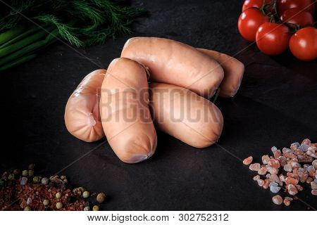 Closeup Group Of Short Sausages With Dill And Tomatoes