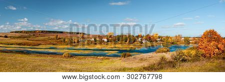 Panoramic View To The Small River Near The Village At The Hills As Background, A Panorama From Sever