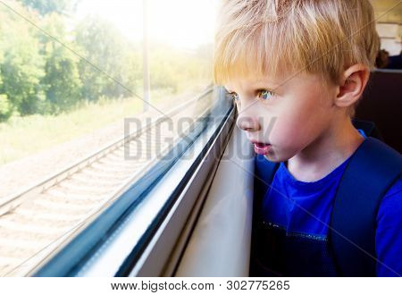 Surprised Kid In The Train By The Window