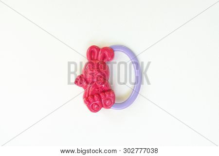 Newbor Toy Bunny. A Colorful Baby Rattle On A White Horizontal Background