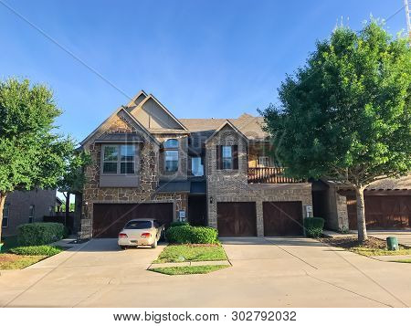 Front Entrance Of Brand New House With Wooden Garage Doors Near Dallas, Texas