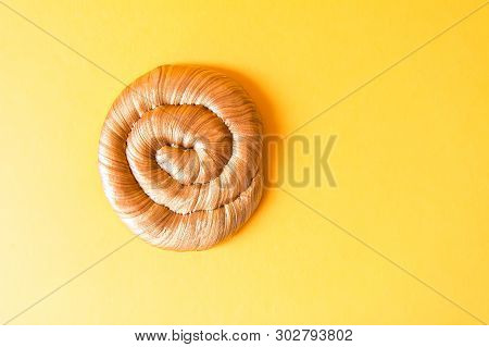 Golden Plasticine Soft Stretchable Texture On Yellow Background. Anti-stress Toy For Kids Activities