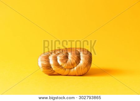 Golden Plasticine Soft Stretchable Texture On Yellow Background. Anti-stress Toy For Kids Activities