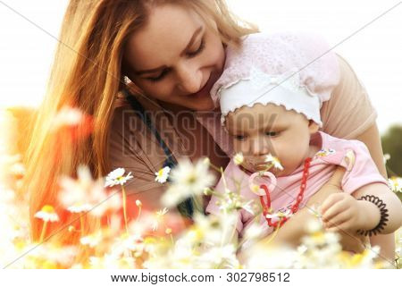 Young Mother With Her Little Daughter In Summer