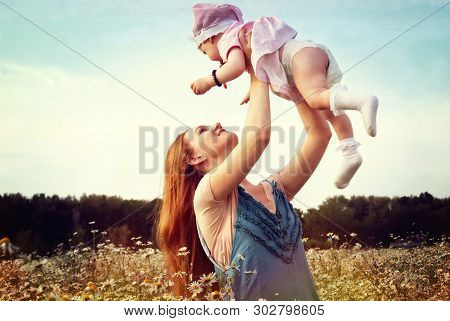 Mother With A Child In Nature Summer