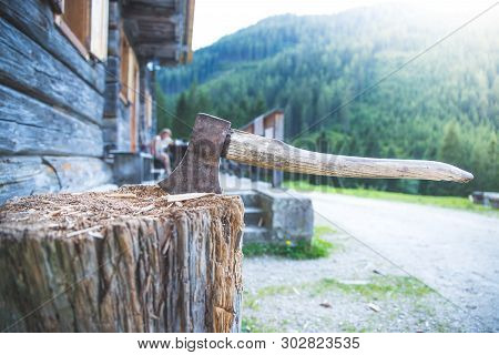 Getting Wood For Fire: Axe Attached To A Tree Trunk