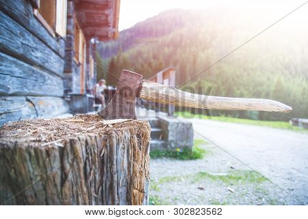 Getting Wood For Fire: Axe Attached To A Tree Trunk
