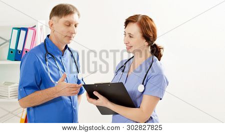 Two Doctors Is Diskussion Something In Medical Office Clinic, Doctor And Nurse, Medical Insurance