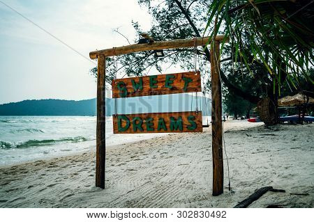 Sweet Dreams Inscription On A Wooden Board The Name Of The Hotel And The Beach On A Tropical Island.