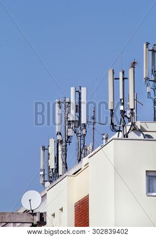 Telecommunication Base Stations Network Repeaters On The Roof Of The Building. The Cellular Communic