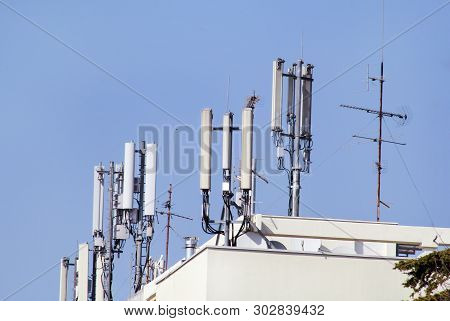 Telecommunication Base Stations Network Repeaters On The Roof Of The Building. The Cellular Communic