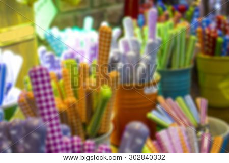 Blurred Multi-color Background Storefront Dishes, Cutlery Spoons, Forks, Knives With Colored Handles