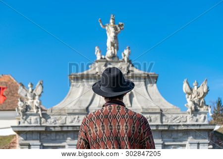 A Tourist Young Man With A Hat Admiring A Fortress Gate Entrance. A Man Admiring The 3Rd Gate Of The