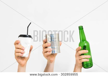 Waste Management And Sorting. Plastic, Paper, Glass, Metal. Different People Hands Holding Disposabl