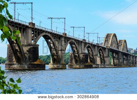Beautiful Landscape Of The Ukrainian  Dnipro City With Old Arch Railway Merefo-kherson Bridge Across