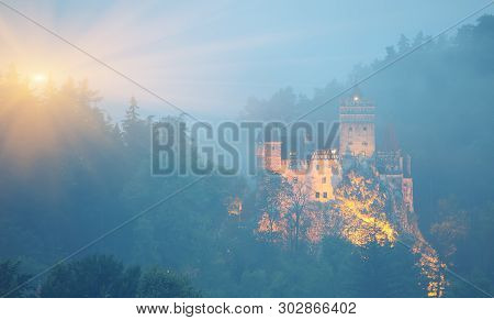 Misty Morning View Of Bran Castle Known For The Myth Of Dracula. Bran Or Dracula Castle In Transylva