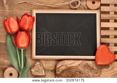 Spring Holiday Background: Blackboard Framed With Red Tulips Onl Wooden Background, Space For Your T