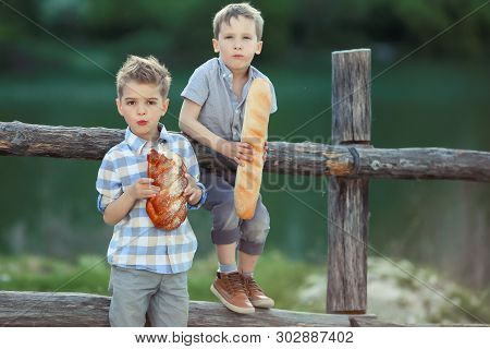 A Boys Stand Near Wooden Fence In A Willage.