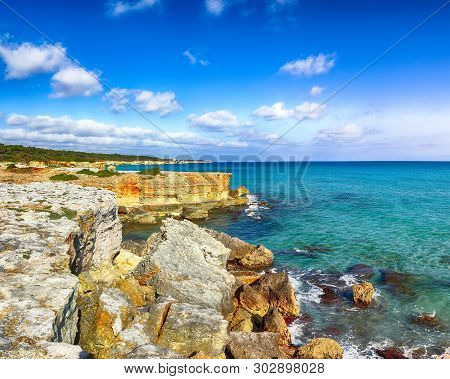 Picturesque Seascape With White Rocky Cliffs, Sea Bay, Islets And Faraglioni Near By Conca Specchiul
