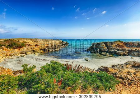 Picturesque Seascape With White Rocky Cliffs, Sea Bay, Islets And Faraglioni Near By Conca Specchiul