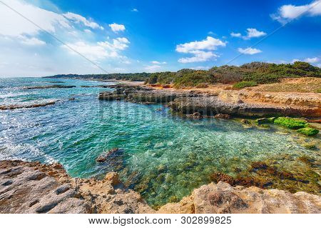 Picturesque Seascape With White Rocky Cliffs, Sea Bay, Islets And Faraglioni Near By Conca Specchiul