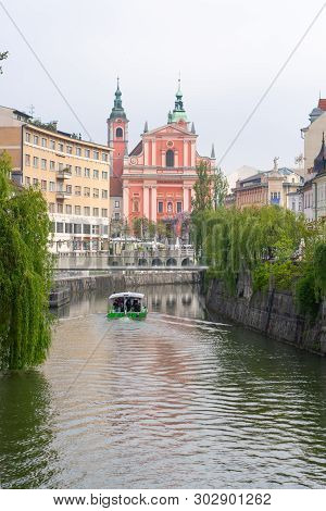 Franciscan Church On Preserns Street And Boat Crossing Ljubljanica