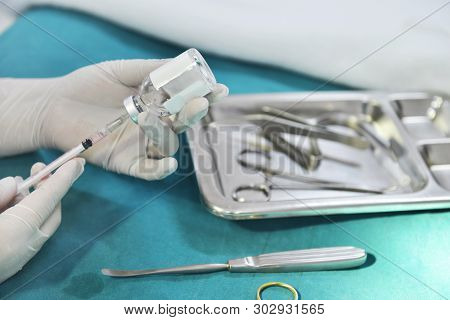 Hand Holding Syringe And Medicine Vial Prepare For Injection With Surgical Equipment And Medicine Vi