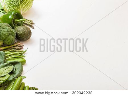Assorted Green Toned Raw Organic Vegetables On White Background. Avocado, Cabbage, Broccoli, Caulifl