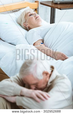 Sad Senior Man And Senior Woman In Coma In Hospital