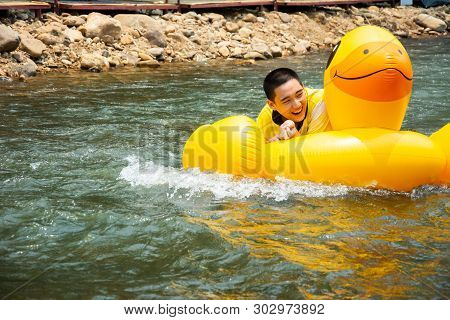 Boy Enjoy And Has Fun Rowing Downstream On Canal