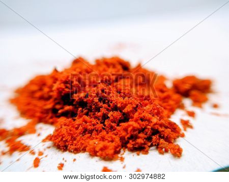 A Picture Of Red Chili Powder On White Background