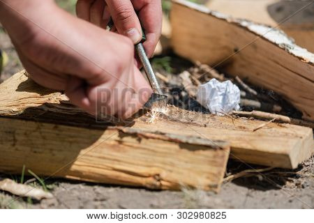 A Pair Of Hands Making A Fire With Flint And Steel