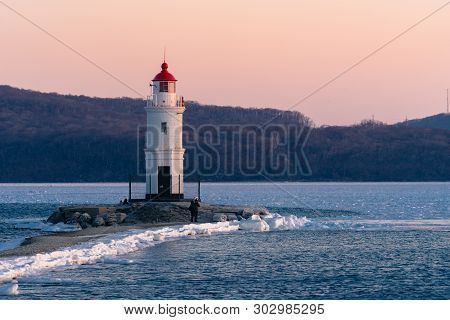 Vladivostok, Russia-january 2, 2019: White Lighthouse With Red Roof On Tokarev Cat.