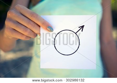Gender Definition Concept, A Piece Of Paper With  Male Symbol In A Woman's Hand