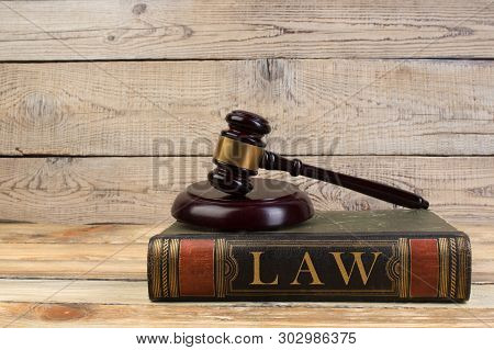 Judge Gavel On The Book On Wooden Table. Justice And Law Concept.