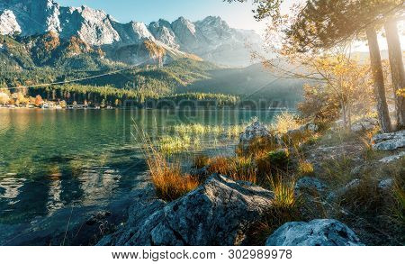 Impressive Autumn Landscape The Eibsee Lake In Front Of The Zugspitze Under Sunlight. Amazing Sunny 