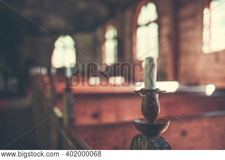 Medieval Baltic Church Interior With Sun Rays From The Window Falling On The Candles.