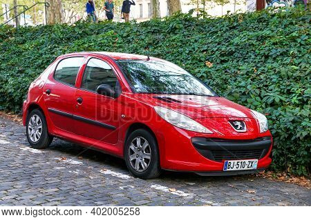 Versailles, France - September 15, 2019: Red Compact Car Peugeot 206+ In The City Street.