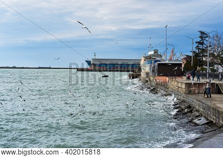 Tuapse, Russia, - December 26, 2020. Port Of Small Town Of Tuapse In South Of Russia, People Feed Br